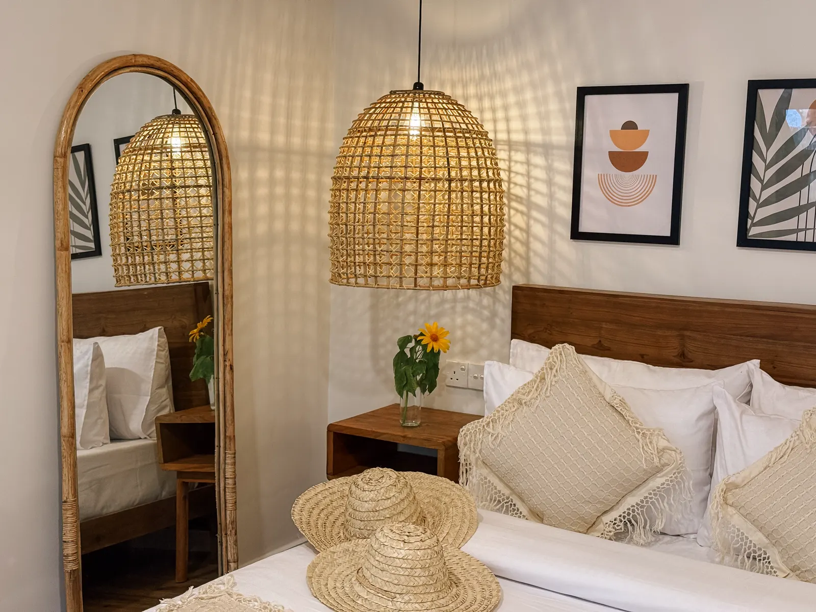 Finished boutique guest room at Kickin’ Surf Lodge with timber furniture and rattan lighting