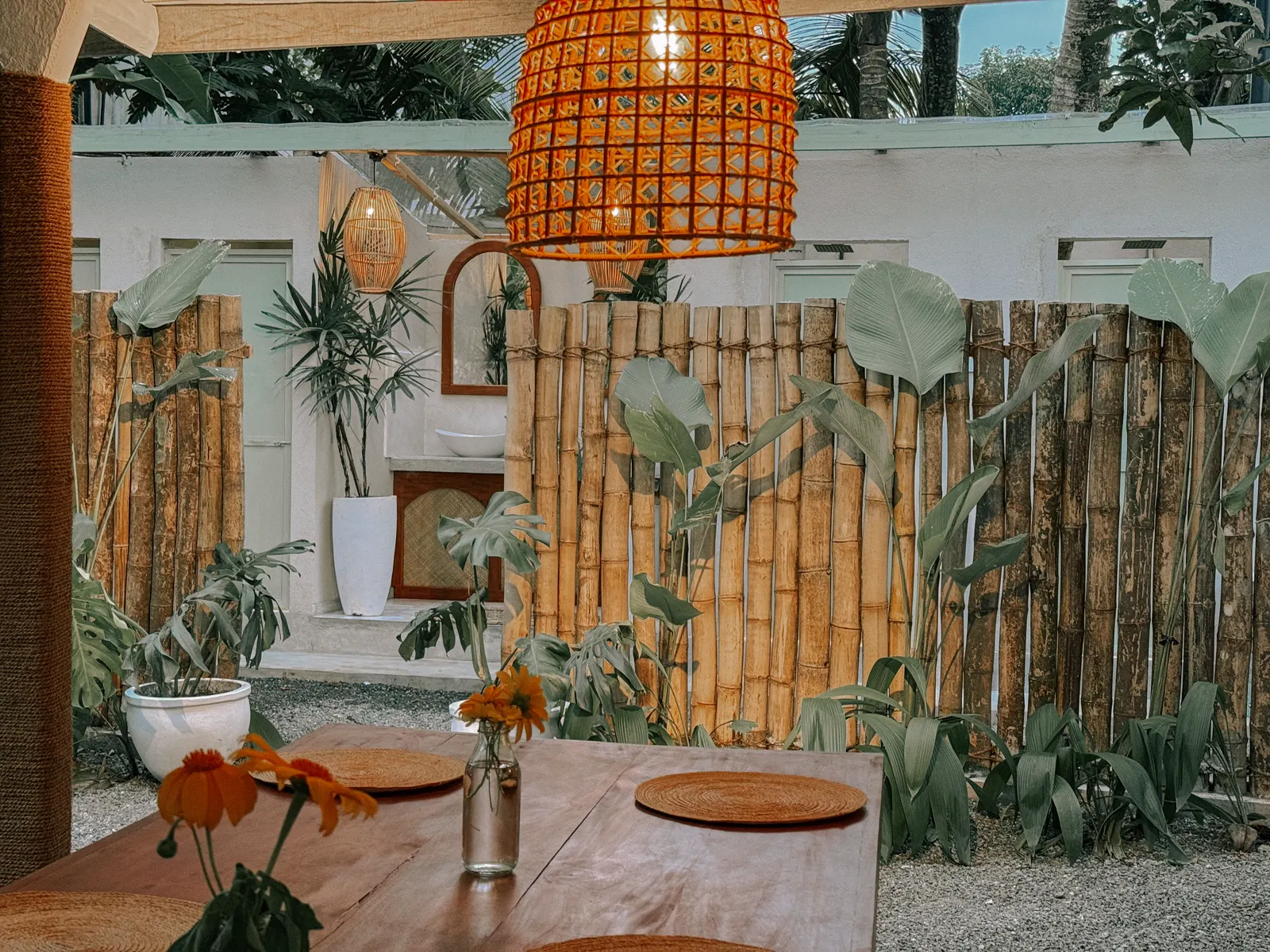 Communal dining area with bamboo landscaping at Kickin’ Surf Lodge in Sri Lanka