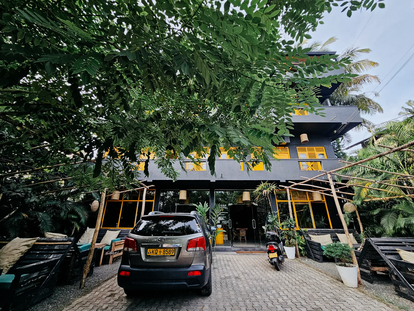 The completed black and yellow exterior of Sugar Hostel Weligama