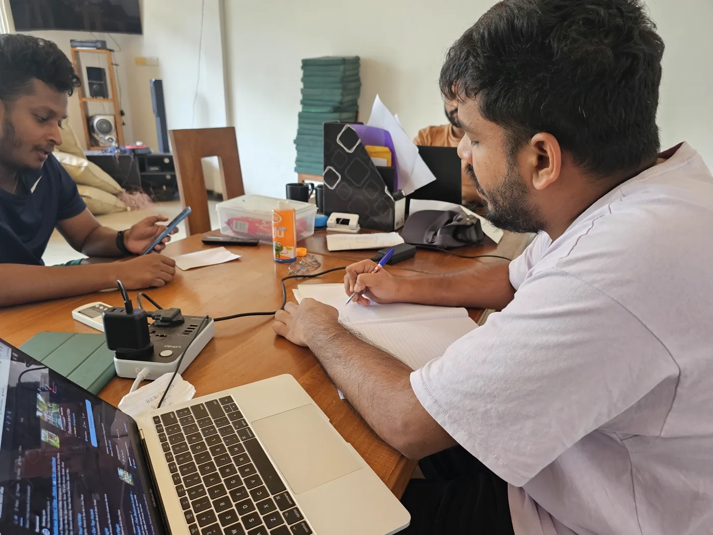 The Sugar Hostel team planning together around a laptop